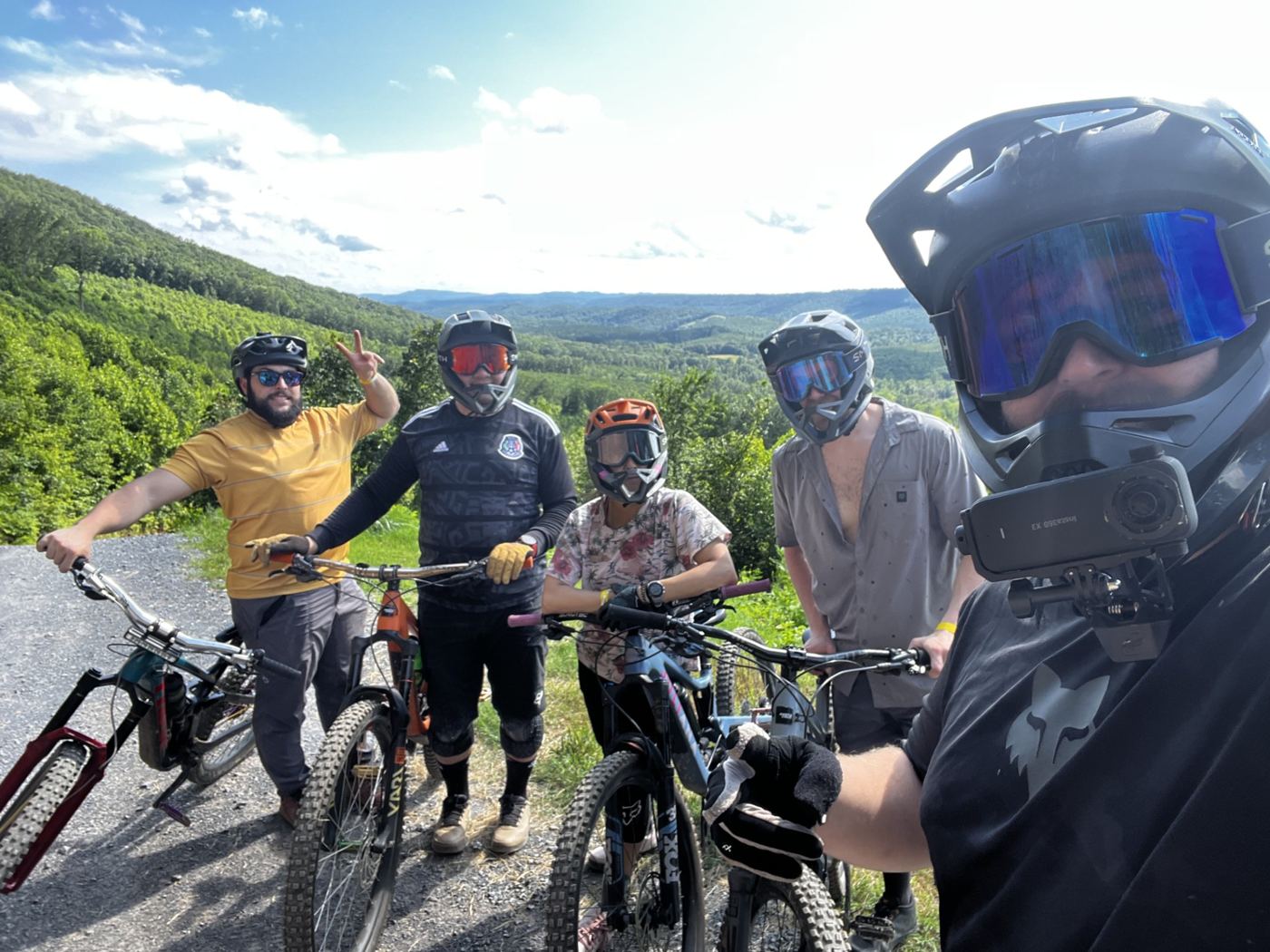 A group of mountain bikers with their bikes at a scenic overlook